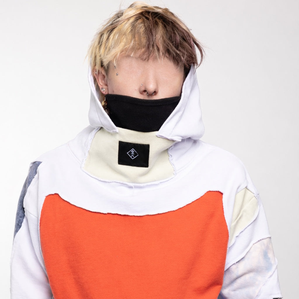 Person wearing colorful Couture hoodie Maison Habit